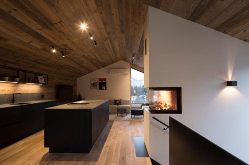 a kitchen with a fireplace in the middle of a room at Haus Sonnblick Chalet in Reith im Alpbachtal