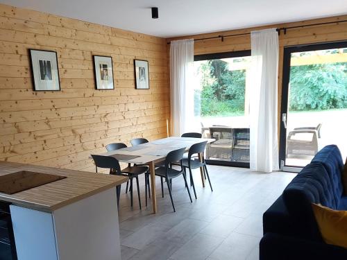 a dining room with a table and chairs at Dom przy lesie in Wielgie