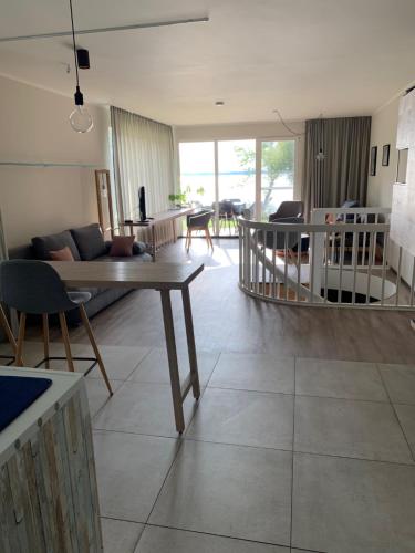 a living room with a couch and a table at Ferienwohnung am See mit Terrasse in Ascheberg