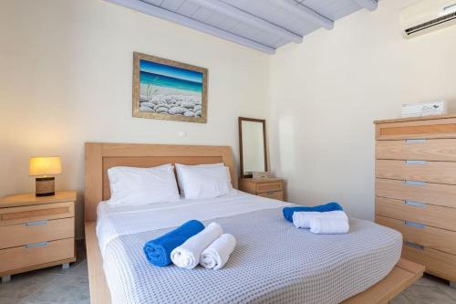a bedroom with a bed with two towels on it at 'Nepheli' Mykonean Suite in Ornos