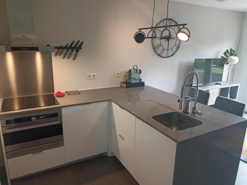 a kitchen with a sink and a stove at B&B Villa Branca Barreiros AL98139 in Barreiros