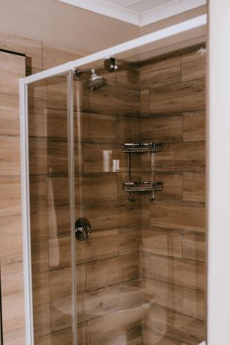 a shower with a glass door in a bathroom at La Bendicion in eMalahleni