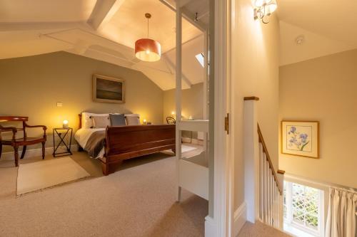 a bedroom with a bed and a dining room at Bell Tower Cottage in Middleton