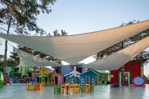 a playground with colorful tables and chairs under awning at Vogue Hotel Supreme Bodrum in Torba