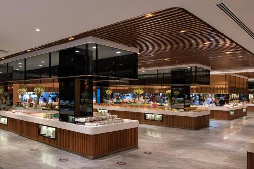 a shopping mall with many counters in a building at Vogue Hotel Supreme Bodrum in Torba