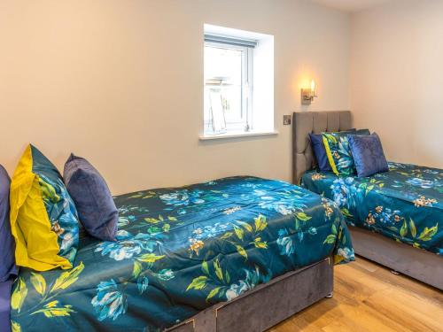 a bedroom with a bed and a bed and a window at The Linden Suite - Uk40475 in Willerby