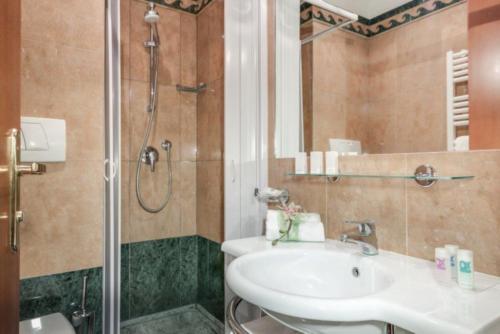 a bathroom with a sink and a shower at Palazzo Cardinal Cesi in Rome
