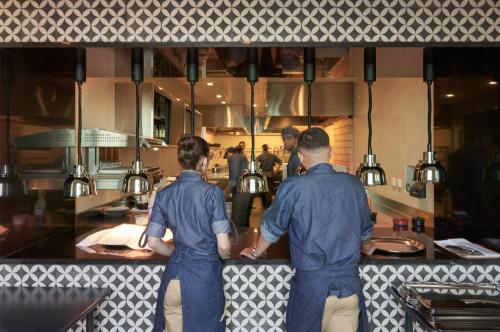 two men standing at a counter in a kitchen at Les Suites at The Cliff Bay - PortoBay in Funchal