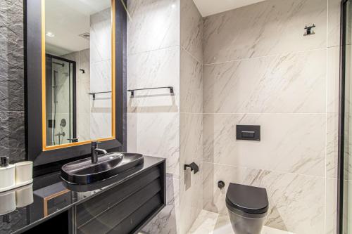 a bathroom with a sink and a toilet at Centrally Located Flat with Balcony in Beyoglu in Istanbul