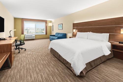 a hotel room with a large bed and a desk at Holiday Inn Express Hotel & Suites Willows, an IHG Hotel in Willows