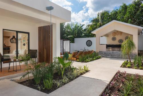 a house with a courtyard with a patio at Illa Cozumel in Cozumel