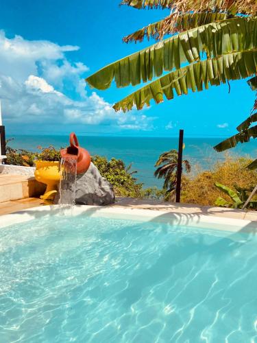 a plunge pool with the ocean in the background at Montepascual Ecovillage in Lagoinha