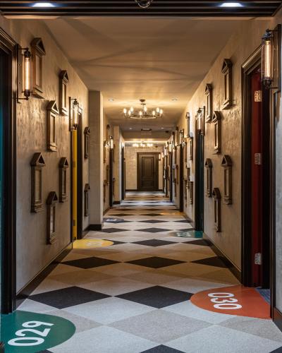 a hallway in a building with a tile floor at Emily Magic Hostel in Vynnyky