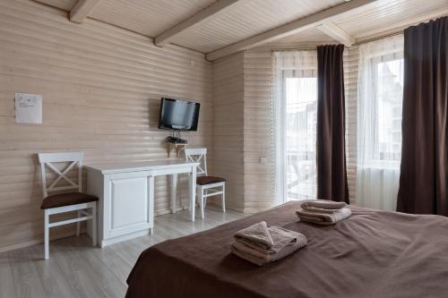 - une chambre avec un lit et une télévision murale dans l'établissement Villa Morishka & SPA, à Bukovel
