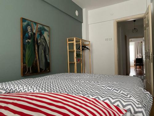 a bedroom with a bed with a painting on the wall at Comfortable house in Üsküdar İstanbul Turkey in Istanbul