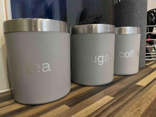 four coffee cups sitting on top of a table at Modern studio apartment - great location! in Mansfield