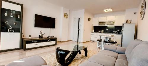 a living room with a couch and a table at Lighthouse Golf Resort, 75 mp2, with balcony in Balchik