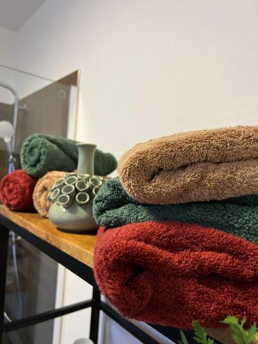a pile of towels sitting on a wooden shelf at City Prüm in Prüm