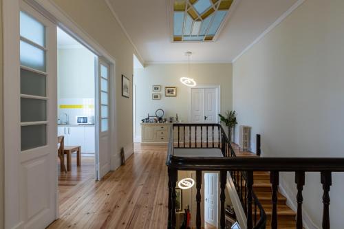 a hallway of a home with a staircase and a living room at Sky Accommodations Studio in Coimbra