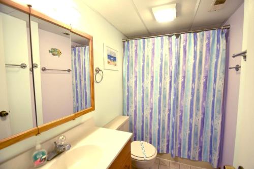 a bathroom with a sink and a shower curtain at Thunder Island 157D condo in Ocean City
