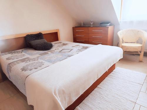 a bedroom with a large bed and a dresser at Vila Safin in Poprad