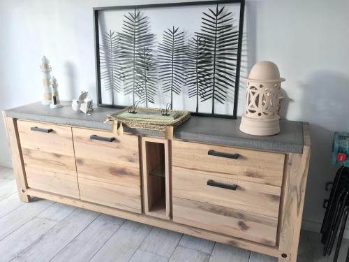 a wooden dresser with a tv on top of it at Ty Breizh in Saint-Nic