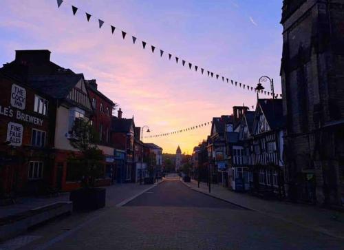 an empty street in a town with a string of houses at No5 at 53 - 2 bed apartment in Leek, Staffs Peak District in Leek