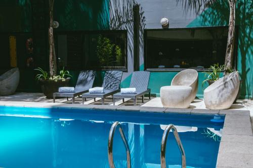 a group of chairs sitting next to a swimming pool at Deco Collection in Buenos Aires
