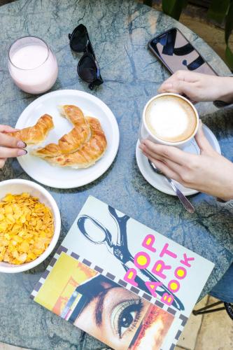 a table with two plates of food and a cup of coffee at Deco Collection in Buenos Aires