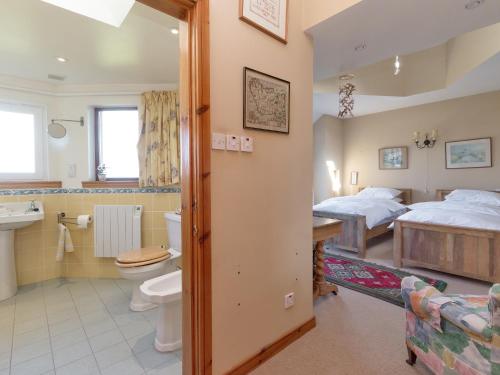 a bedroom with two beds and a bathroom at Bentfield in Prestwick