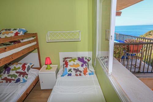 a bedroom with two beds and a balcony with the ocean at CABO Palos 4 2 2 ONLY FAMILIES in Salou