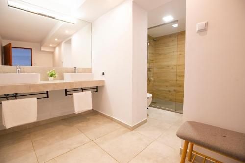 a bathroom with two sinks and a shower at Rudy Lis Szczyrk in Szczyrk