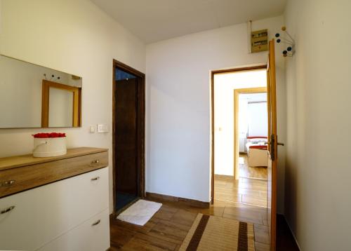 a kitchen with a dresser and a door to a room at Apartment Vanessa in Gospić