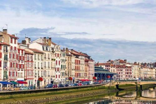 a group of buildings next to a river at Maison Muruzabal Etxea in Espelette