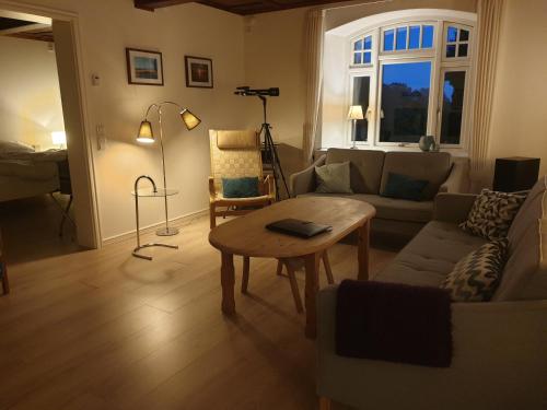 a living room with a couch and a table at Fjordvejen Apartments in Gråsten