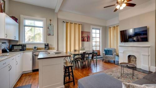 a kitchen and living room with a table and a fireplace at Huge 5 bed, 5 bath in Historic Downtown Savannah in Savannah