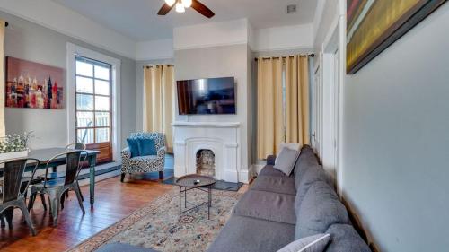 a living room with a couch and a fireplace at Huge 5 bed, 5 bath in Historic Downtown Savannah in Savannah