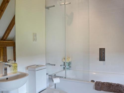 a bathroom with a shower and a sink at Cowford Oast in Mark Cross