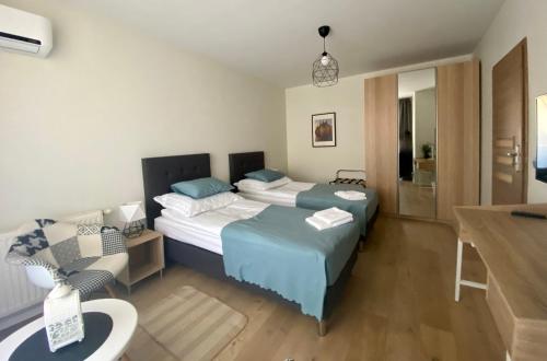 a hotel room with two beds and a bathroom at Wrocław Premium Apartment 4You in Wrocław