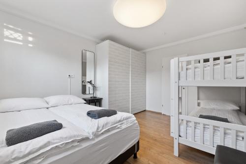 een witte slaapkamer met een stapelbed en een ladder bij Odinn Reykjavik Eiriksgata Apartments in Reykjavík