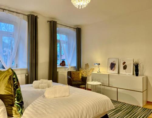 1 dormitorio con 1 cama, 1 silla y ventanas en VOH SUPER EXKLUSIVES LOFT, ZENTRAL, Smart-TV, Parkplatz en Vohenstrauß
