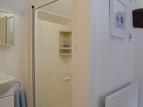 a shower with a glass door in a bathroom at The Beehive in Betley