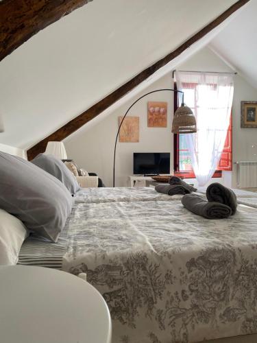 a bedroom with a large bed with pillows on it at El Balcón del Eume, Cantina Río Covés in Puentedeume