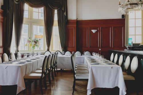 a row of tables in a room with white tablecloths at The Queens Hotel in Portsmouth