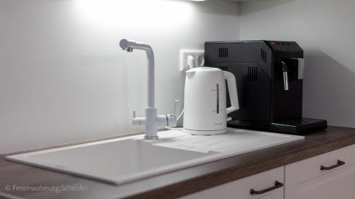 a kitchen counter with a coffee maker and a mixer at Ferienwohnung Schröder in Barntrup