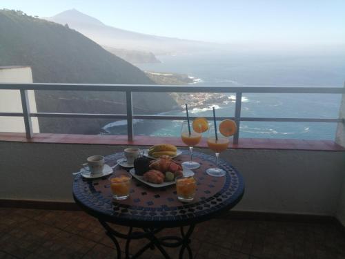 a table with a plate of food on a balcony at Estudio Puntillo del Sol in Puntillo del Sol