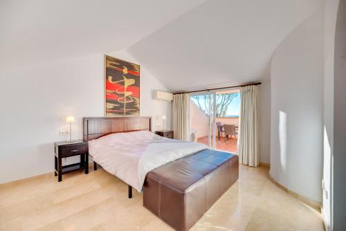 a bedroom with a large bed and a window at Penthouse Apartment in Elviria in Marbella