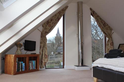 a bedroom with a bed and a large window at Kingston House in Kirkwall