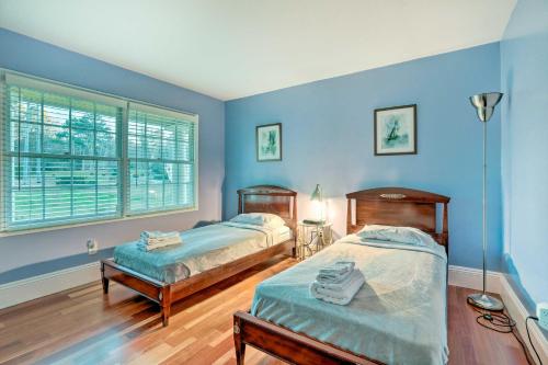 two beds in a room with blue walls at Atlanta Abode with Yard in a Tranquil Setting! in Norcross