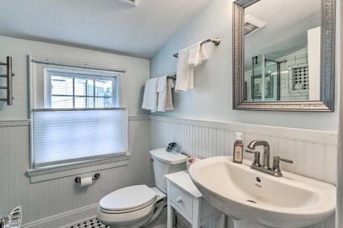 a bathroom with a sink and a toilet and a mirror at Townhome in Leesburg Historic District! in Leesburg